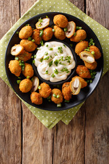 Snack fried green olives stuffed with almonds close-up. Vertical top view