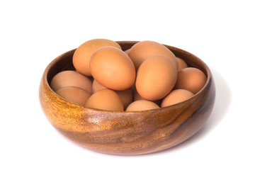 Egg in a wooden bowl isolated on white background.