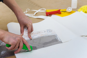 A worker doing markups and cutting paperhungs