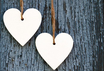 Decorative white wooden hearts on blue old wooden background with copy space.Selective focus.Holidays,Love,Valentine's Day concept.