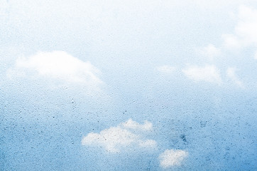 Water drops and sky through glass background.