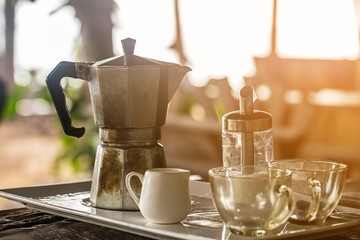 vintage coffee grinder  with roasted coffee bean on morning sunlight  background.