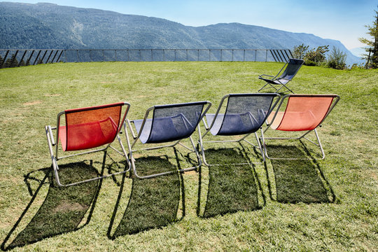 five deck chairs on the terrace with panoramic views on the mountains