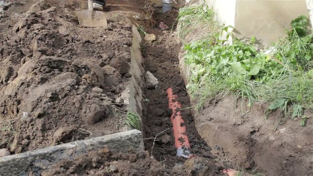 bury pipes/shovel throw soil on sewage pipes