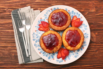 Cottage cheese patties with strawberry jam.