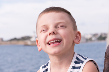 cute laughing little boy wearing striped shirt