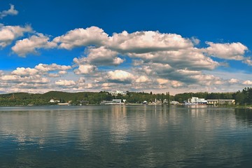 Fototapeta premium Brno dam. South Moravia. Czech Republic Europe. Recreational area of entertainment and sports. Beautiful countryside with nature, clear water and sky with sun and clouds.