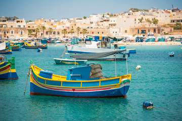 Fototapeta na wymiar fishing boats near fishing village of Marsaxlokk (Marsascala) in Malta