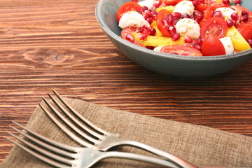 Tomato salad, mango and mozzarella with pomegranate seeds