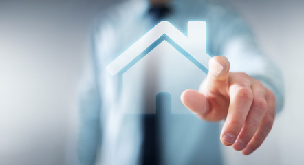 Businessman touching 3D rendering icon house with his finger