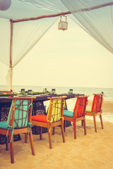 Table and chair set on the beach for dinner