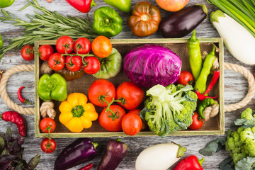 Set of raw vegetables in the wooden tray