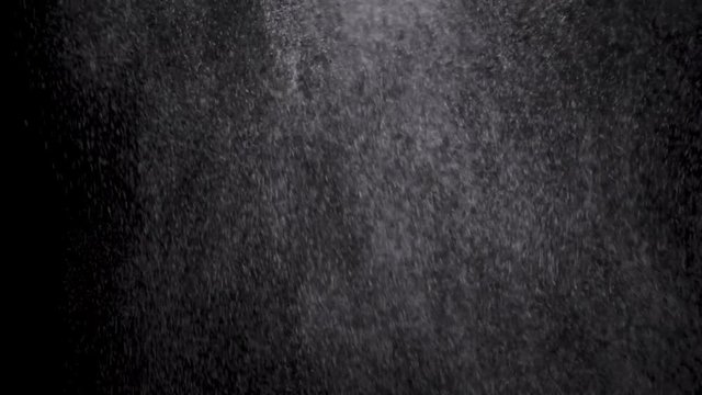 White powder exploding isolated on black