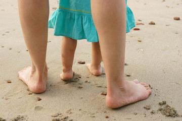 Mother and daugher playing on beach