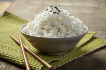A bowl of rice on a fabric mat