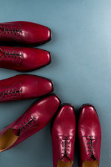 Red oxford shoes on blue background. Three pair  brogues. Top view.