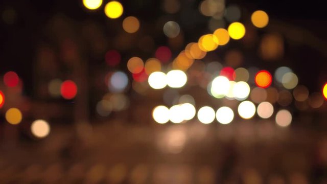DEFOCUSED BOKEH: Traffic jam on busy road in crowded New York City street during the night. Colorful blurred car headlights and flashing traffic lights glowing in the dark creating magical atmosphere