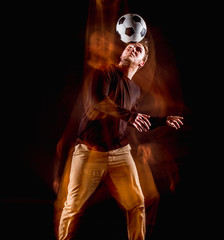 A portrait of a fan with ball on gray studio background. Freestile
