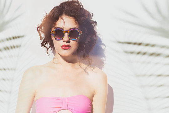 Summer style portrait of young attractive woman wearing sunglasses. Tropical holiday fashion beauty concept 