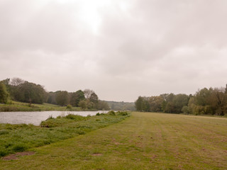 a lovely river running through a park in the uk in spring light natural