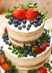 Cake with white cream and fresh berries from the forest