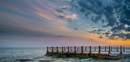 Foto auf Acrylglas Old pier on background of sunset on beach © alexytrener