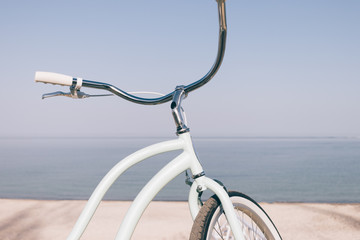 Fototapeta na wymiar Close-up of a blue retro bicycle against the sea on the beach