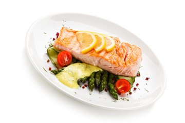Grilled salmon with french fries on cutting board