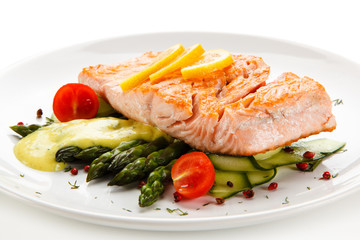 Grilled salmon with french fries on cutting board