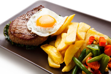 Grilled beefsteak with french fries and egg