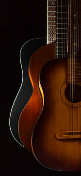 Three acoustic guitars on black background