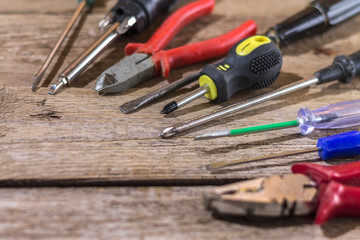 Screwdrivers and other tools on a wooden surface