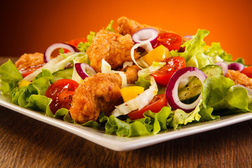 Fried chicken nuggets with vegetable salad