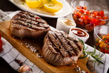 Grilled beefsteaks on cutting board - dinner preparation