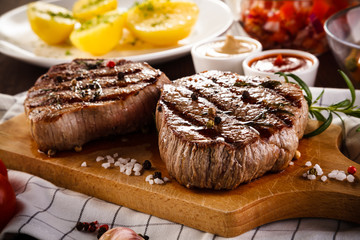 Grilled beefsteaks on cutting board - dinner preparation