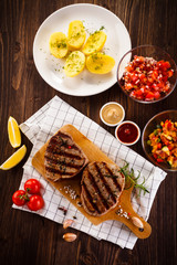Grilled beefsteaks on cutting board - dinner preparation
