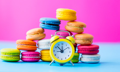 colorful macaroons and alarm clock