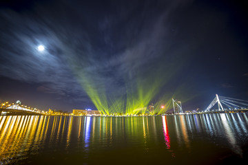 Light beams over river Daugava in Riga Latvia