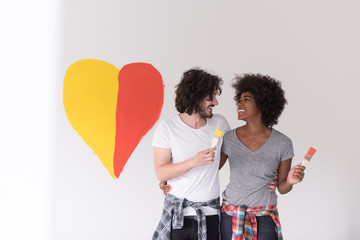 couple with painted heart on wall