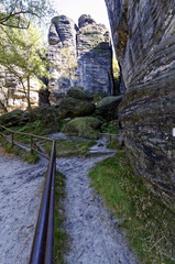 Grill is placed for the path between the rocks