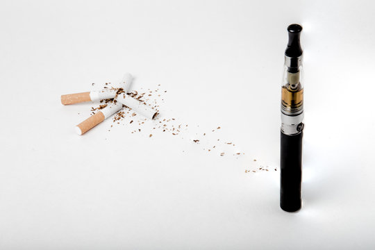Broken tobacco cigarettes with modern electronic cigarette