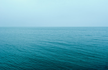 Obraz premium Two color abstract background, calm water surface, small ripples