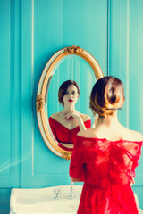 young woman looking at mirror