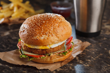 burger served with fries on stone table