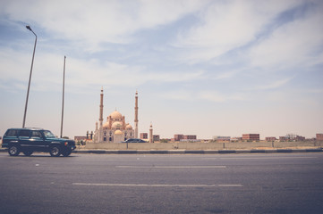 Fototapeta na wymiar cairo, egypt, may 6, 2017: laylat al-qadr mosque at cairo ismaileya desert road with view of car