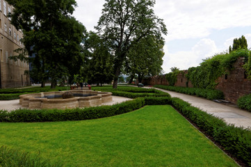 Small fountain in the lawn with wall