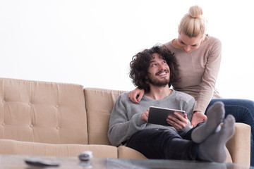 couple relaxing at  home with tablet computers