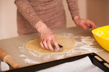 Woman making cookies in kitchen closeup. Cooking.