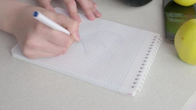 Drawing a heart on a piece of paper