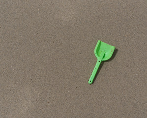 Dirty Green Shovel on Beach